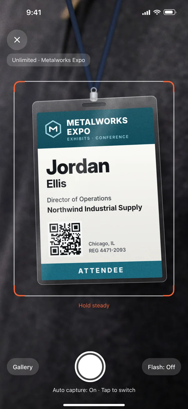 The Tendro app's camera framing a printed Metalworks Expo badge for Jordan Ellis, Director of Operations at Northwind Industrial Supply, with auto-capture on